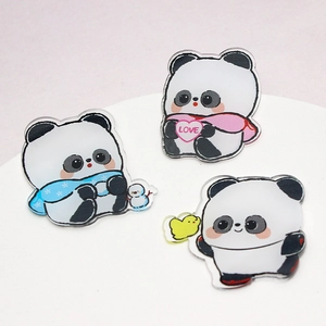 Detailed macro of three panda acrylic charms with love heart and snowman designs