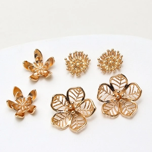 Three assorted golden cast brass flower charms for DIY jewelry making and earring design