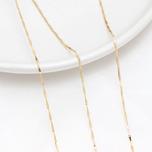 Close-up of 14K gold plated bamboo chain link showing polished metallic luster and texture