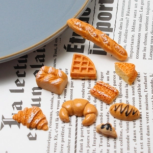 Miniature resin bakery charms including croissants and baguettes for DIY crafts
