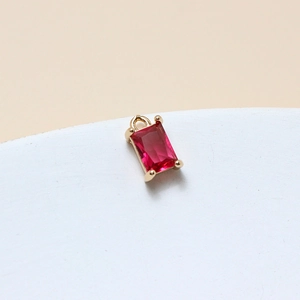 Detail of red rectangular crystal pendant with gold claw setting and top jump ring