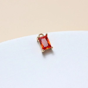 Detail of 6x10mm rectangular red crystal pendant with gold claw setting for DIY jewelry