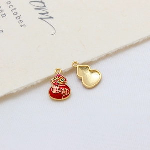 Macro shot of red enamel gourd pendants with golden auspicious text on a cozy background