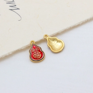 Detail of gold-plated calabash charms with red enamel and lucky Fu character engraving