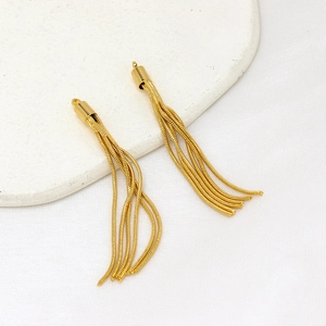 Macro detail of 14K gold-plated tassel pendants with fine snake chains for DIY jewelry