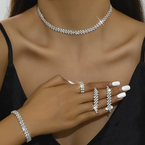 Close-up of elegant rhinestone jewelry set with wave pattern worn by female model