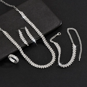 Macro shot of silver bridal jewelry set with sparkling rhinestones on black background
