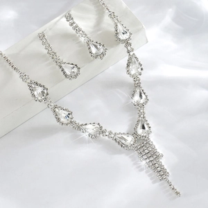 Detailed view of silver crystal jewelry set with teardrop necklace and matching earrings