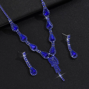 Detailed close-up of crystal water drop necklace and earrings set with blue rhinestones