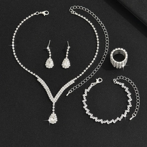 Sparkling silver crystal jewelry set with necklace earrings bracelet and ring on black background