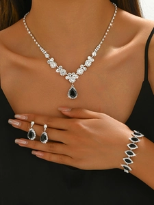 Detailed close-up of bridal jewelry set with black teardrop zircon stones on a model
