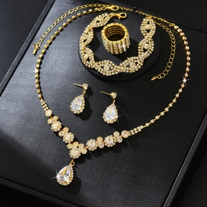 Luxurious gold-plated jewelry set with sparkling teardrop zircons on a dark display box