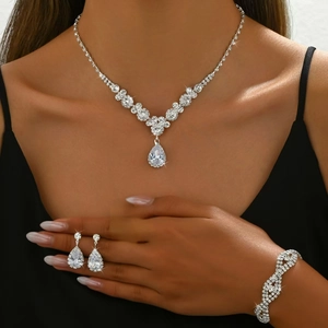 Elegant silver bridal jewelry set with pear-cut cubic zirconia necklace, bracelet, and earrings