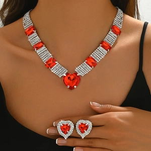 Fashion silver metal jewelry set with red heart gems and rhinestones on female model