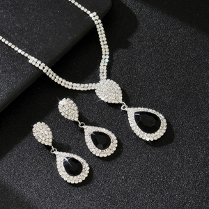 Detail of luxury water drop jewelry set with black stones and shimmering silver rhinestones