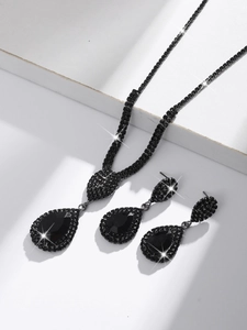 Detail of elegant black rhinestone water drop jewelry set featuring necklace and earrings