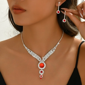 Bridal jewelry set with red crystals necklace and earrings worn by a model