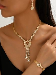 Close-up of sparkling bow tassel jewelry set with rhinestone inlay on female model