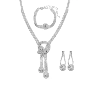 Sparkling silver bow jewelry set including crystal necklace, bracelet and earrings