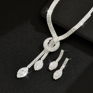 Elegant bridal crystal jewelry set with necklace and earrings on a black background