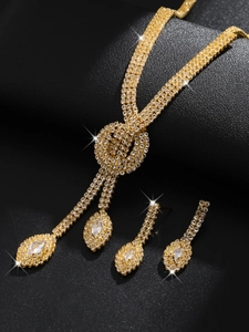 Detailed view of bridal crystal jewelry set with golden rhinestones on black background