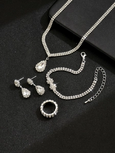 Detailed view of luxury silver bridal jewelry set with sparkling water-drop crystals