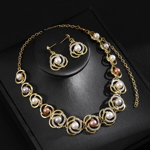 Elegant multi-layered gold pearl necklace set with matching earrings on a display box