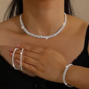 Detail of a sparkling silver rhinestone jewelry set including necklace, bracelet and earrings