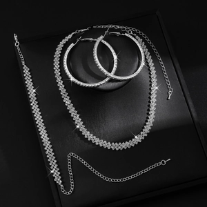 Sparkling silver-tone rhinestone jewelry set with necklace, bracelet, and hoop earrings