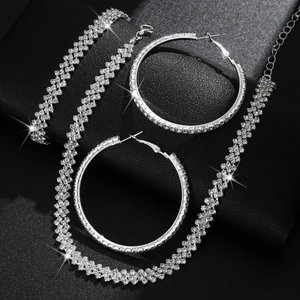 Elegant silver-toned jewelry set with sparkling rhinestones, necklace, bracelet and earrings