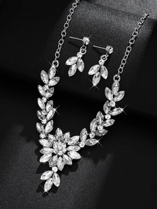 Detailed macro of floral silver bridal jewelry set with sparkling marquise rhinestones