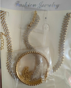 Detail showing crystal rhinestone jewelry set with necklace and large hoop earrings