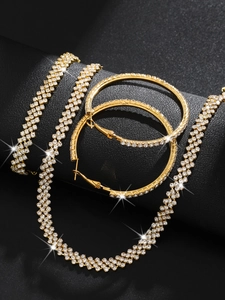 Detailed view of luxury gold-plated rhinestone necklace and large hoop earrings set