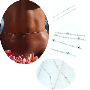 Detail of silver beaded waist chain for beach bikinis showing the fine chain link texture