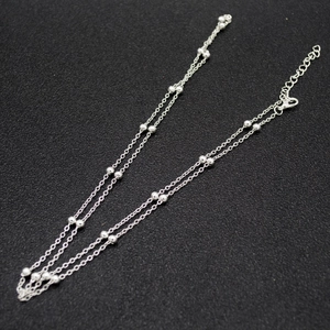 Close-up of double-layer silver bead waist chain with lobster clasp and extension