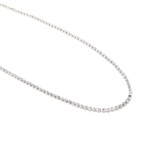Macro detail of silver tennis chain with sparkling round-cut crystals in claw setting