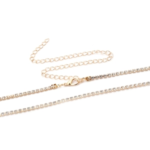 Detail of gold rhinestone tennis chain showing secure lobster clasp and extension link