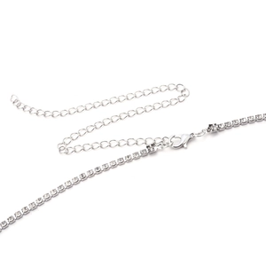Detail of silver rhinestone waist chain showing adjustable lobster clasp and crystal links