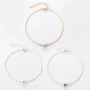 Set van drie enkelbandjes met boze oog in goud en zilver met blauwe kralen