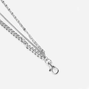Detail of silver multi-layered metal trousers chain with lobster clasp and cuban links