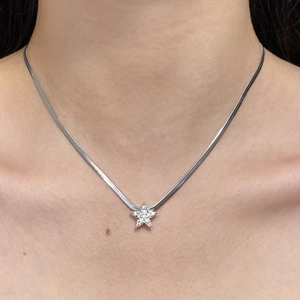 Primer plano detallado de una cadena de serpiente plateada con un colgante de estrella brillante