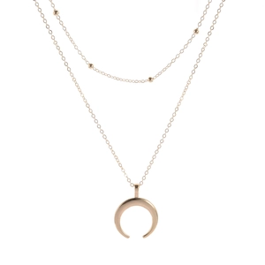 Bohemian gold layered necklace with beads and a polished crescent horn pendant
