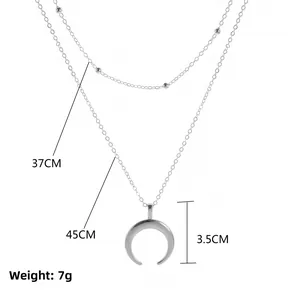 Layered double chain necklace with crescent pendant in silver finish and bead detail