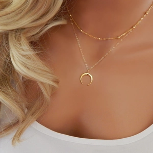 Bohemian gold layered double crescent moon necklace with beaded chain on model