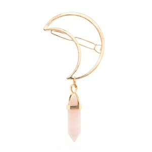 Detail view of gold moon hair clip with a pink hexagonal crystal pillar pendant