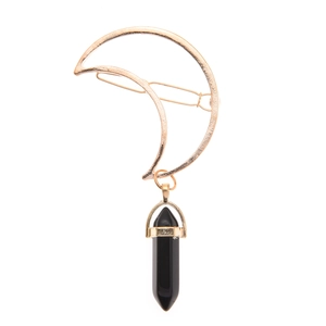 Detail of crescent moon hair clip with black hexagonal crystal pendant on white background
