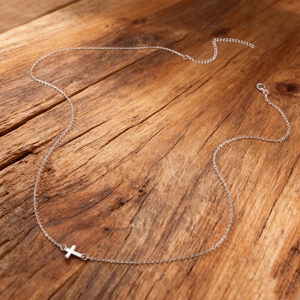 Detailed view of silver alloy cross chain with lobster clasp and adjustable extension link