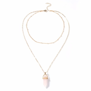 Detail of double-layer gold necklace with pink hexagonal crystal pendant and beaded chain