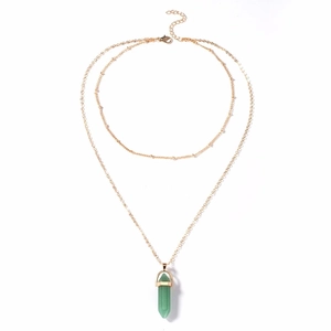 Detail of double-layer gold chain with green hexagonal prism crystal pendant