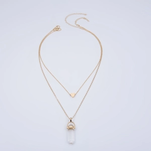 Double-layered gold necklace featuring a heart pendant and hexagonal crystal prism